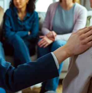 Therapist giving psychological support to a man during therapy session