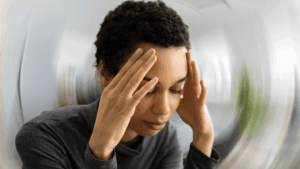 A blurred image of a person experiencing a migraine headache, reflecting the struggles with Topamax.
